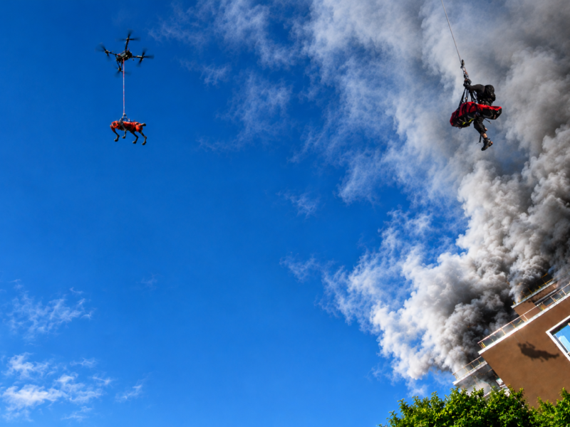 Aerial rescue operation amid thick smoke and flames, demonstrating advanced emergency response and high-altitude search and rescue capabilities.